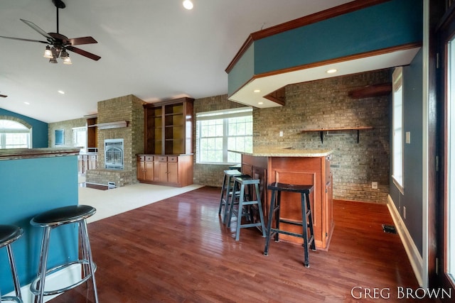 9318 Jefferson Rd, Lakeview, MI 48850 - kitchen featuring a ceiling fan, a fireplace, wood finished floors, open floor plan, and lofted ceiling