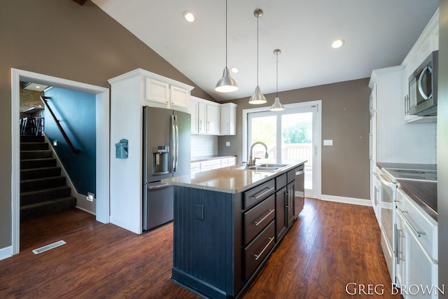 9318 Jefferson Rd, Lakeview, MI 48850 - kitchen with stainless steel appliances, a sink, white cabinets, a kitchen island with sink, and vaulted ceiling