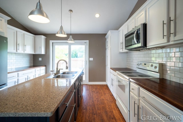 9318 Jefferson Rd, Lakeview, MI 48850 - kitchen with electric stove, stainless steel microwave, a sink, lofted ceiling, and a center island with sink