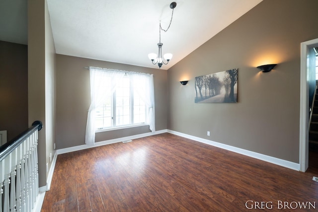 9318 Jefferson Rd, Lakeview, MI 48850 - spare room featuring vaulted ceiling, a chandelier, baseboards, and dark wood-type flooring