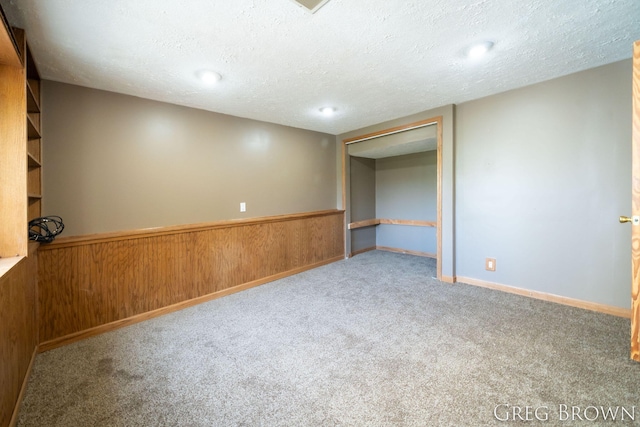 9318 Jefferson Rd, Lakeview, MI 48850 - carpeted spare room with a textured ceiling and wood walls