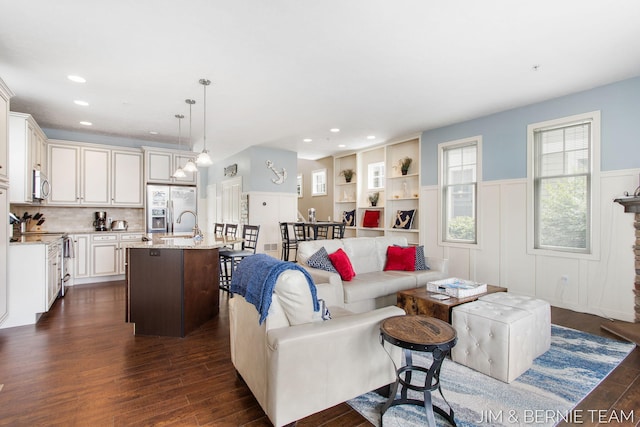 807 Lake St Unit 7, Saugatuck, MI 49453 - living area featuring dark wood-style flooring, a wainscoted wall, recessed lighting, and a decorative wall