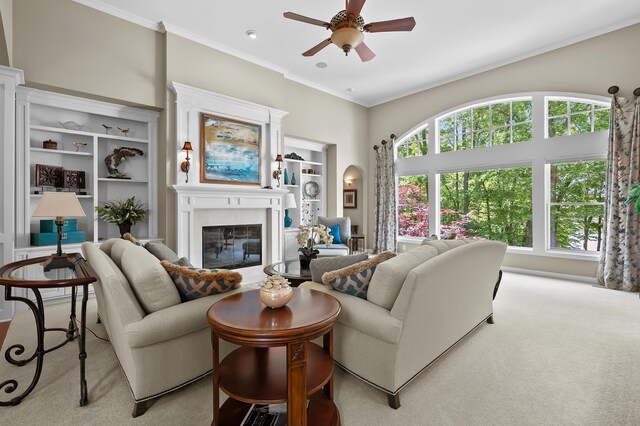 6461 E Bay Ln, Richland, MI 49083 - living area with a glass covered fireplace, a ceiling fan, carpet flooring, and crown molding