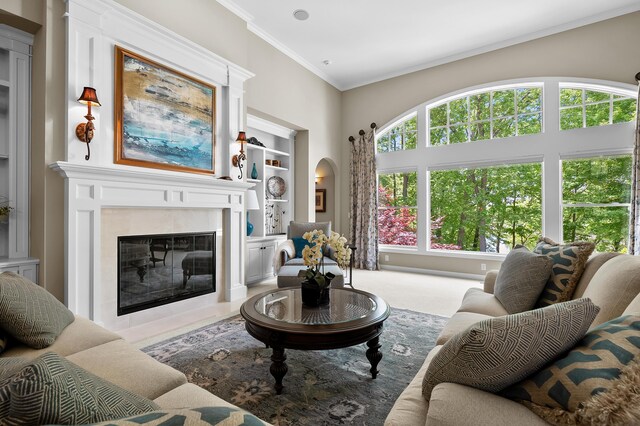 6461 E Bay Ln, Richland, MI 49083 - living room featuring healthy amount of natural light, a fireplace, crown molding, arched walkways, and a towering ceiling