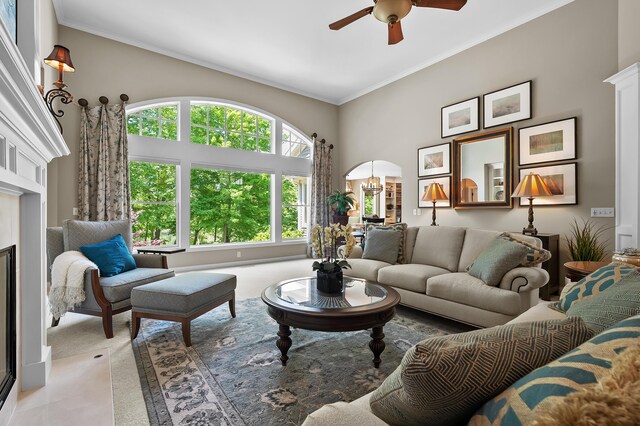 6461 E Bay Ln, Richland, MI 49083 - living room featuring ceiling fan, light carpet, ornamental molding, a chandelier, and a high ceiling