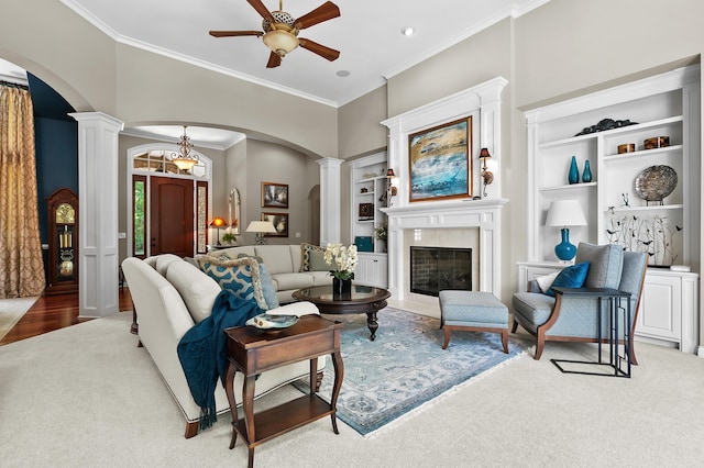 6461 E Bay Ln, Richland, MI 49083 - living room with arched walkways, decorative columns, ceiling fan, crown molding, and a fireplace with flush hearth