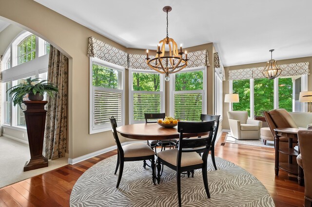 6461 E Bay Ln, Richland, MI 49083 - dining room with a chandelier, wood finished floors, and baseboards