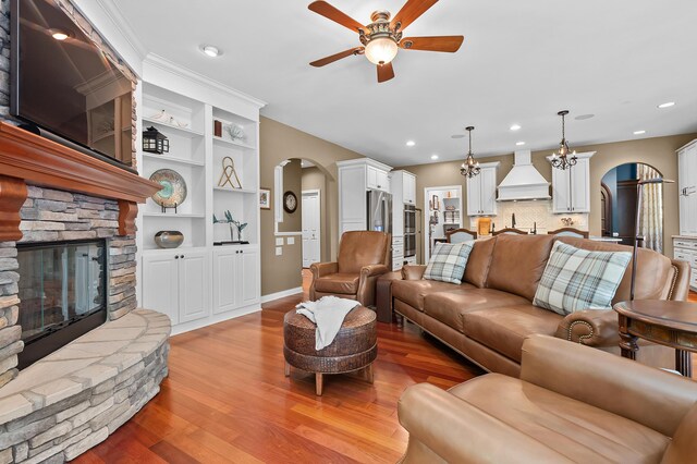 6461 E Bay Ln, Richland, MI 49083 - living room with arched walkways, ceiling fan, light wood finished floors, a fireplace, and recessed lighting
