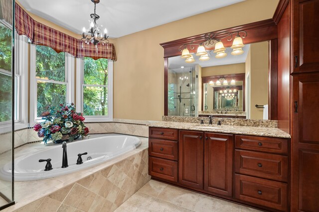 6461 E Bay Ln, Richland, MI 49083 - bathroom featuring a chandelier, vanity, a garden tub, and a shower stall