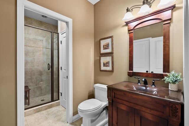 6461 E Bay Ln, Richland, MI 49083 - bathroom with vanity, a shower stall, toilet, and tile patterned floors