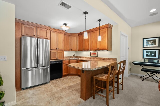 6461 E Bay Ln, Richland, MI 49083 - kitchen with freestanding refrigerator, black dishwasher, a sink, a peninsula, and brown cabinetry