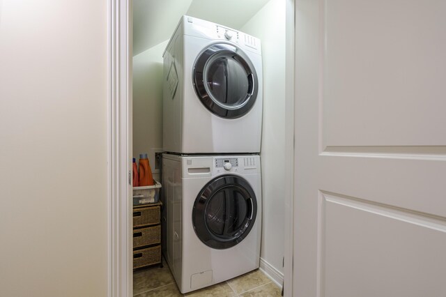 6461 E Bay Ln, Richland, MI 49083 - laundry room featuring stacked washer / dryer and light tile patterned flooring