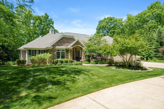 6461 E Bay Ln, Richland, MI 49083 - view of front of house featuring a front lawn, stone siding, and a chimney