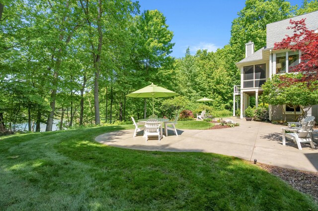6461 E Bay Ln, Richland, MI 49083 - view of green lawn with a sunroom and a patio area