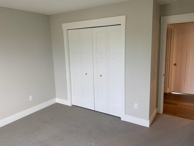 3699 Teton Dr, Hudsonville, MI 49426 - unfurnished bedroom featuring carpet floors, baseboards, and a closet