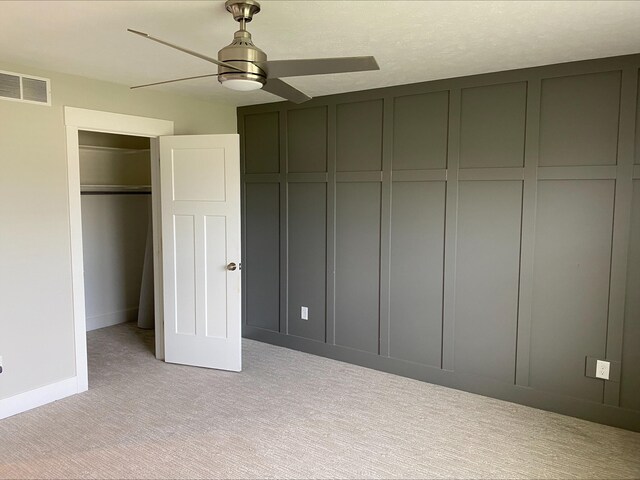 3699 Teton Dr, Hudsonville, MI 49426 - unfurnished bedroom featuring light colored carpet, ceiling fan, baseboards, and a decorative wall