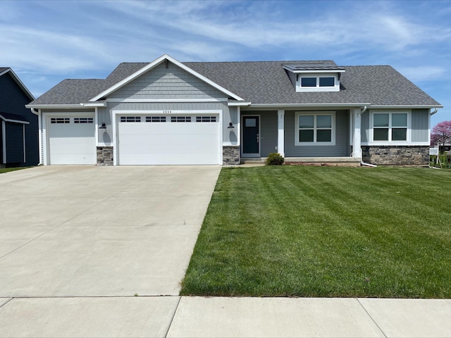 3699 Teton Dr, Hudsonville, MI 49426 - craftsman inspired home with stone siding, an attached garage, concrete driveway, and a front lawn