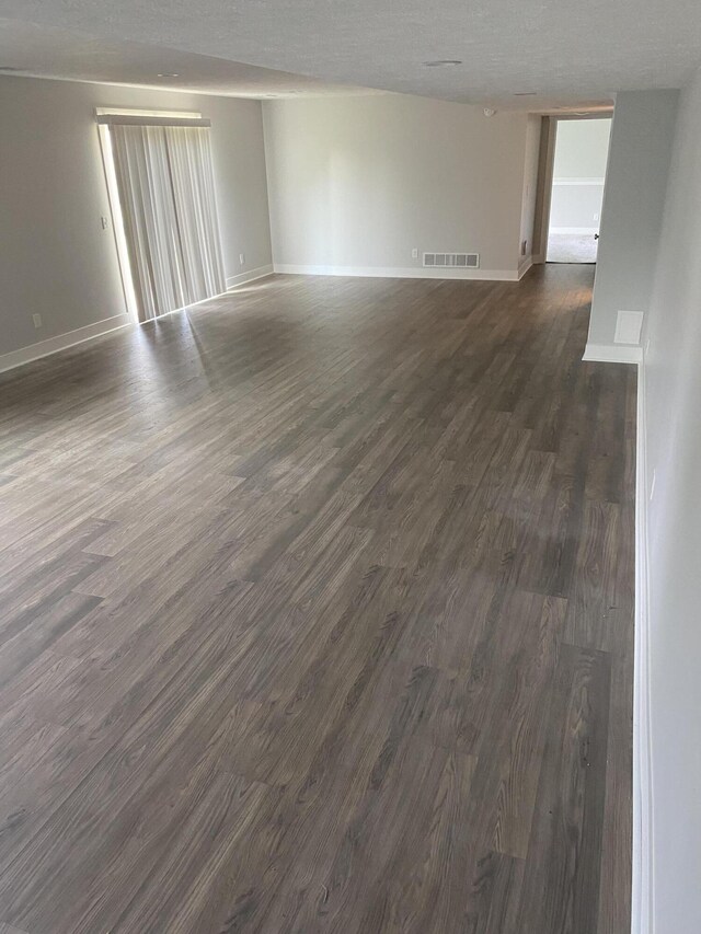 3699 Teton Dr, Hudsonville, MI 49426 - spare room with dark wood-style flooring, baseboards, and a textured ceiling