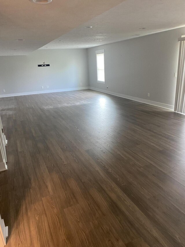 3699 Teton Dr, Hudsonville, MI 49426 - empty room with dark wood-style flooring and baseboards