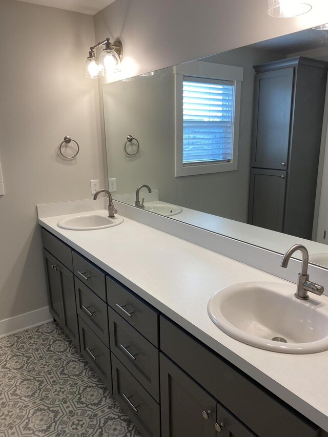 3699 Teton Dr, Hudsonville, MI 49426 - full bath with double vanity, baseboards, and tile patterned floors