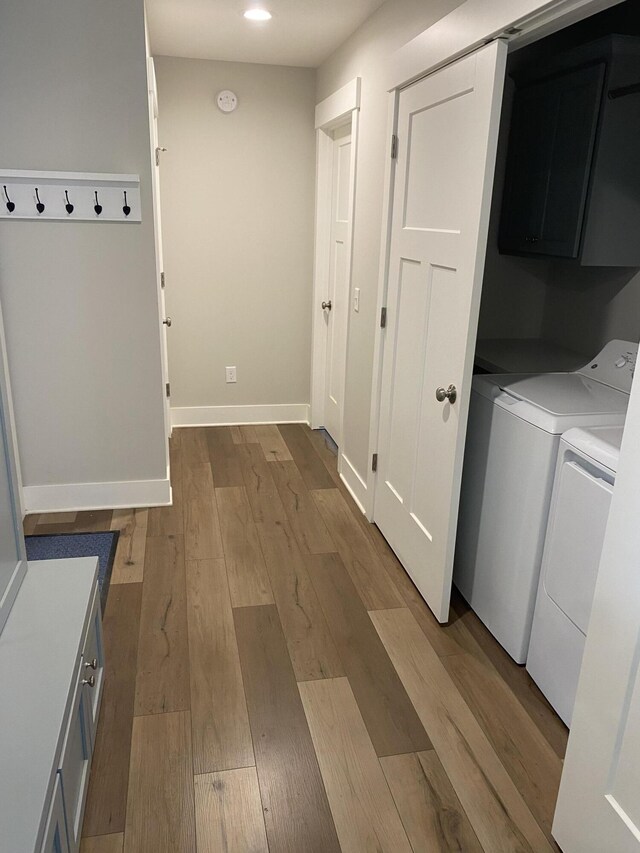 3699 Teton Dr, Hudsonville, MI 49426 - laundry room with cabinet space, washer and dryer, wood finished floors, and baseboards
