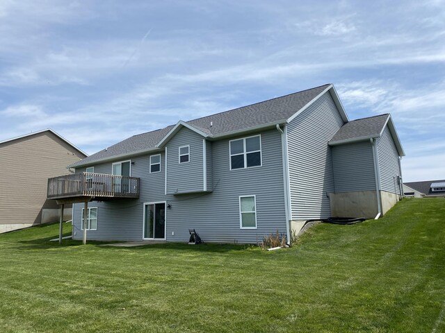 3699 Teton Dr, Hudsonville, MI 49426 - back of house featuring a lawn, a wooden deck, and a shingled roof