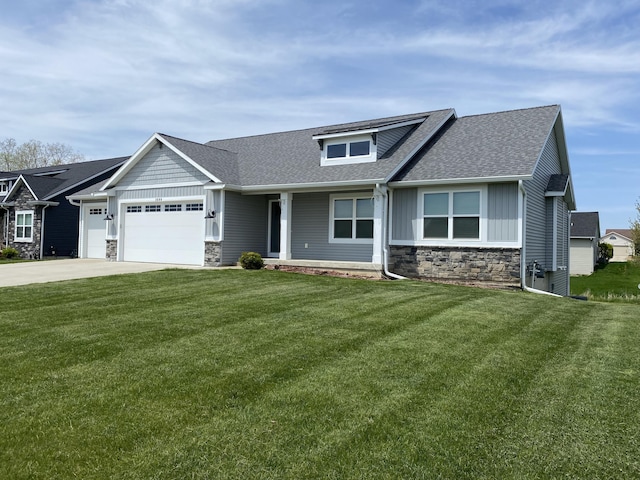 3699 Teton Dr, Hudsonville, MI 49426 - view of front of property with stone siding, a shingled roof, a garage, and a front yard