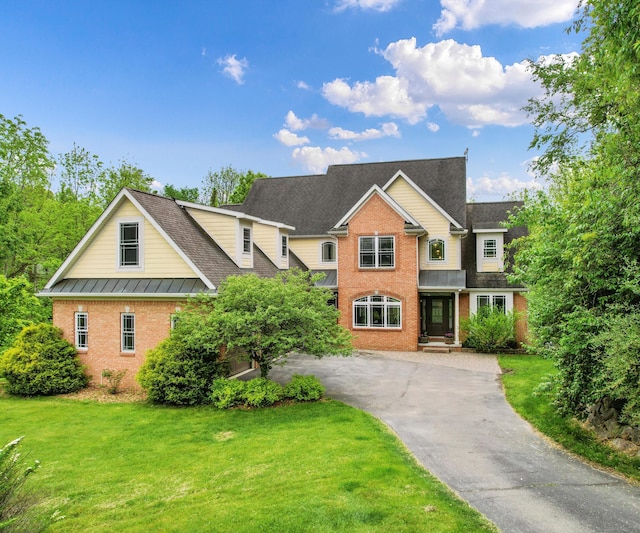6201 Donovanridge, Dexter, MI 48130 - traditional-style house with brick siding, a front yard, and asphalt driveway