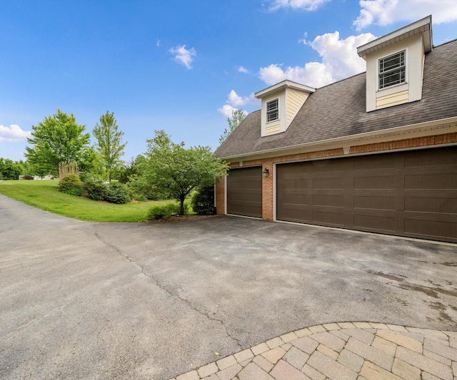 6201 Donovanridge, Dexter, MI 48130 - view of side of property featuring brick siding, asphalt driveway, and a shingled roof