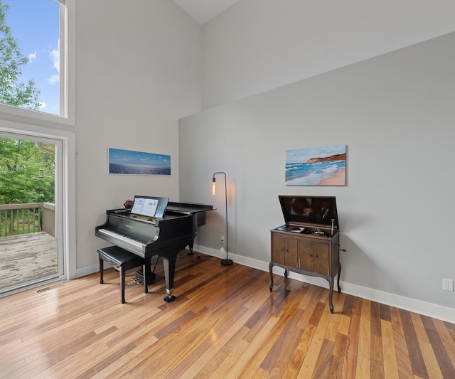 6201 Donovanridge, Dexter, MI 48130 - sitting room featuring a towering ceiling, light wood-style floors, and baseboards