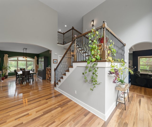 6201 Donovanridge, Dexter, MI 48130 - stairway with arched walkways, a high ceiling, wood finished floors, and recessed lighting