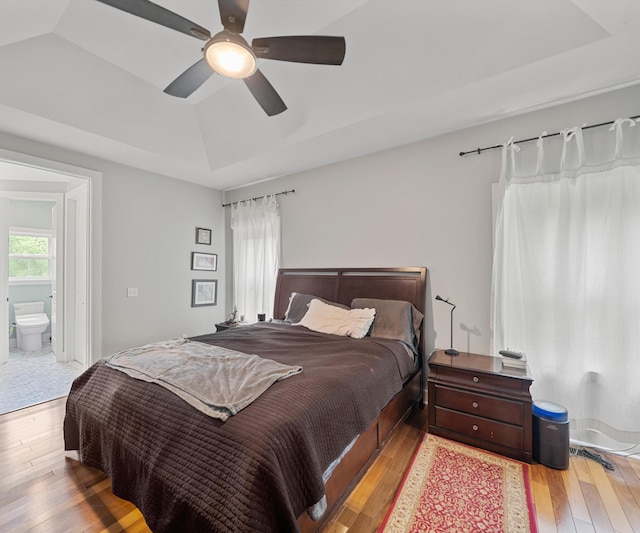 6201 Donovanridge, Dexter, MI 48130 - bedroom featuring light wood-style flooring, a raised ceiling, ceiling fan, and ensuite bath