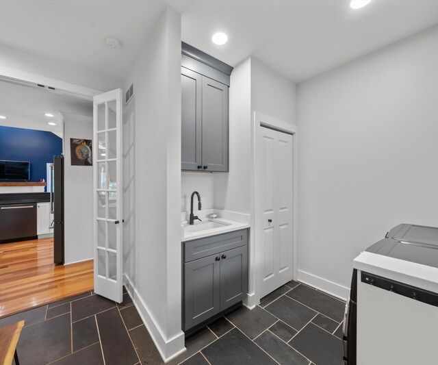 6201 Donovanridge, Dexter, MI 48130 - laundry area with separate washer and dryer, baseboards, dark tile patterned flooring, and recessed lighting