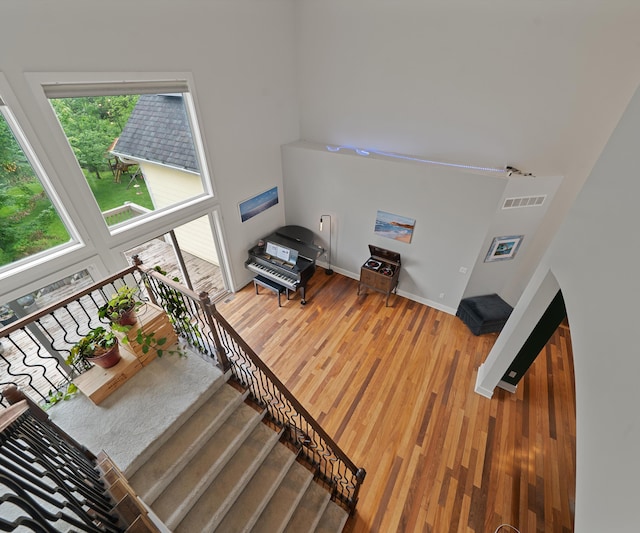 6201 Donovanridge, Dexter, MI 48130 - stairway with wood finished floors, baseboards, and a towering ceiling