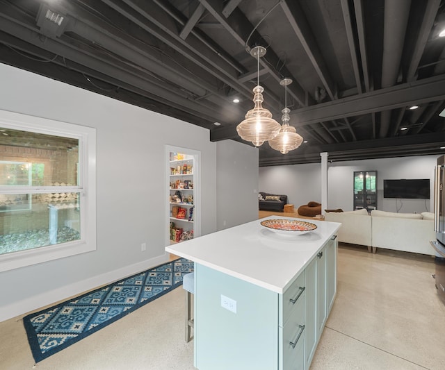 6201 Donovanridge, Dexter, MI 48130 - kitchen featuring a kitchen island, light countertops, pendant lighting, open floor plan, and a kitchen bar