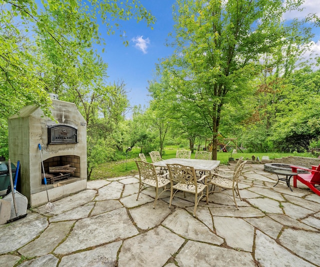 6201 Donovanridge, Dexter, MI 48130 - view of patio featuring an outdoor stone fireplace and outdoor dining space