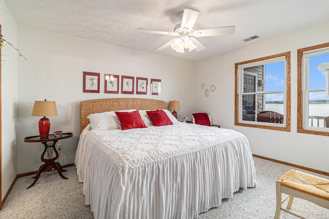 47 Arthur St, Manistee, MI 49660 - bedroom with light colored carpet, baseboards, and ceiling fan