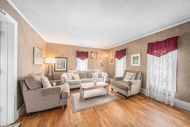 436 Portage St, Grass Lake, MI 49240 - living area featuring hardwood / wood-style flooring, a textured ceiling, ornamental molding, wallpapered walls, and baseboards