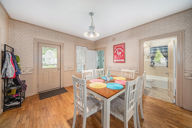 436 Portage St, Grass Lake, MI 49240 - dining space featuring light wood-type flooring, healthy amount of natural light, wallpapered walls, and crown molding