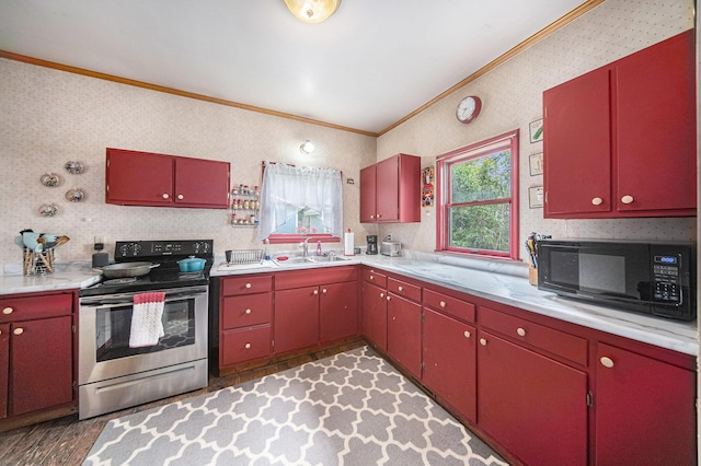 436 Portage St, Grass Lake, MI 49240 - kitchen with stainless steel range with electric cooktop, ornamental molding, black microwave, red cabinets, and wallpapered walls