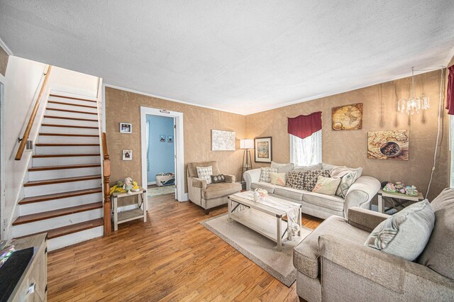 436 Portage St, Grass Lake, MI 49240 - living area with wood finished floors, stairway, and a textured ceiling