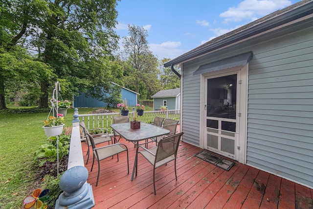 436 Portage St, Grass Lake, MI 49240 - wooden deck featuring outdoor dining area and a yard