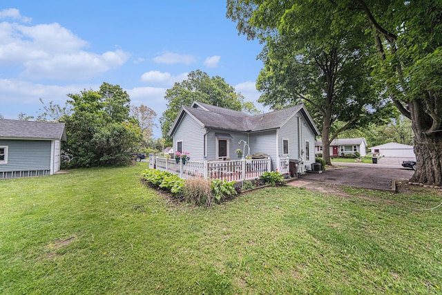 436 Portage St, Grass Lake, MI 49240 - view of home's exterior with a yard, a deck, and central AC