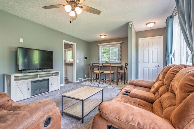 1949 Grove Rd, Ypsilanti, MI 48198 - living area with carpet, ceiling fan, a textured ceiling, and baseboards