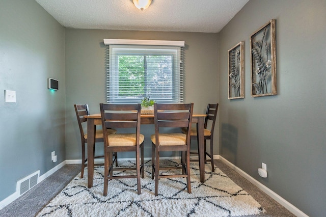 1949 Grove Rd, Ypsilanti, MI 48198 - dining area featuring carpet flooring, baseboards, and a textured ceiling