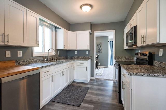 1949 Grove Rd, Ypsilanti, MI 48198 - kitchen with appliances with stainless steel finishes, a sink, dark wood-style floors, and white cabinets