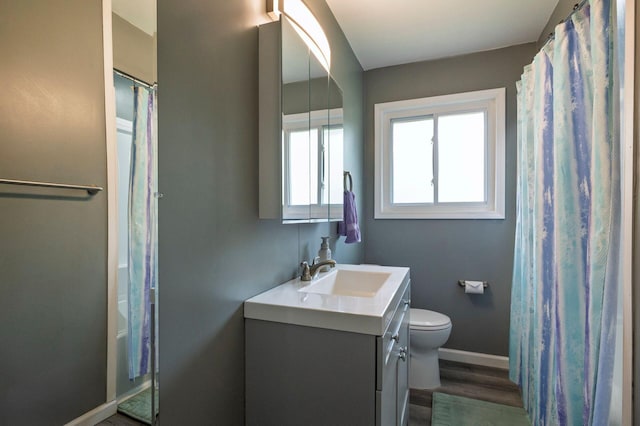 1949 Grove Rd, Ypsilanti, MI 48198 - bathroom with vanity, toilet, baseboards, wood finished floors, and curtained shower