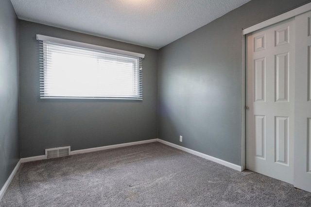 1949 Grove Rd, Ypsilanti, MI 48198 - spare room with carpet flooring, a textured ceiling, and baseboards