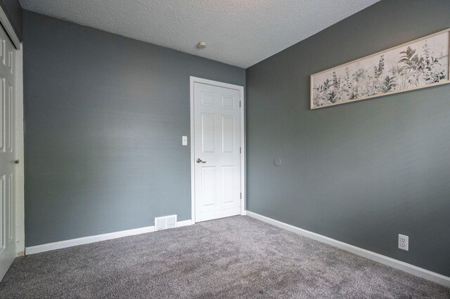 1949 Grove Rd, Ypsilanti, MI 48198 - unfurnished room with carpet, baseboards, and a textured ceiling