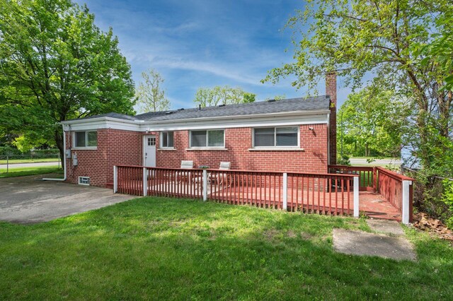 1949 Grove Rd, Ypsilanti, MI 48198 - back of house with a chimney, brick siding, a yard, and a patio